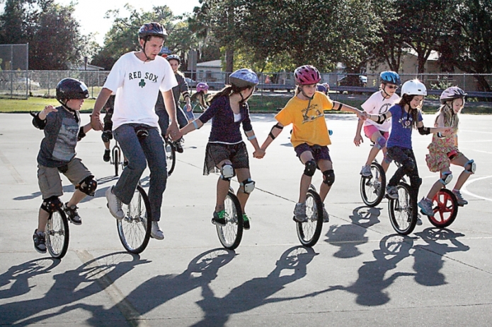 Kids riding unicycles
